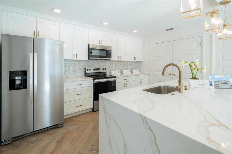 Stainless steel appliances adorn your kitchen.