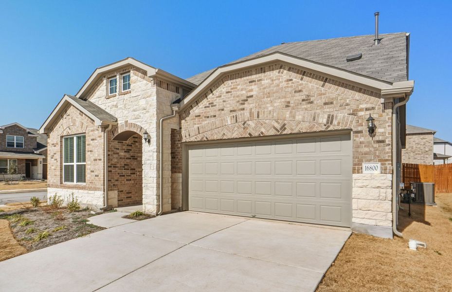 Front exterior of a new home in Lagos, Manor, TX, highlighting curb appeal (Image 22).
