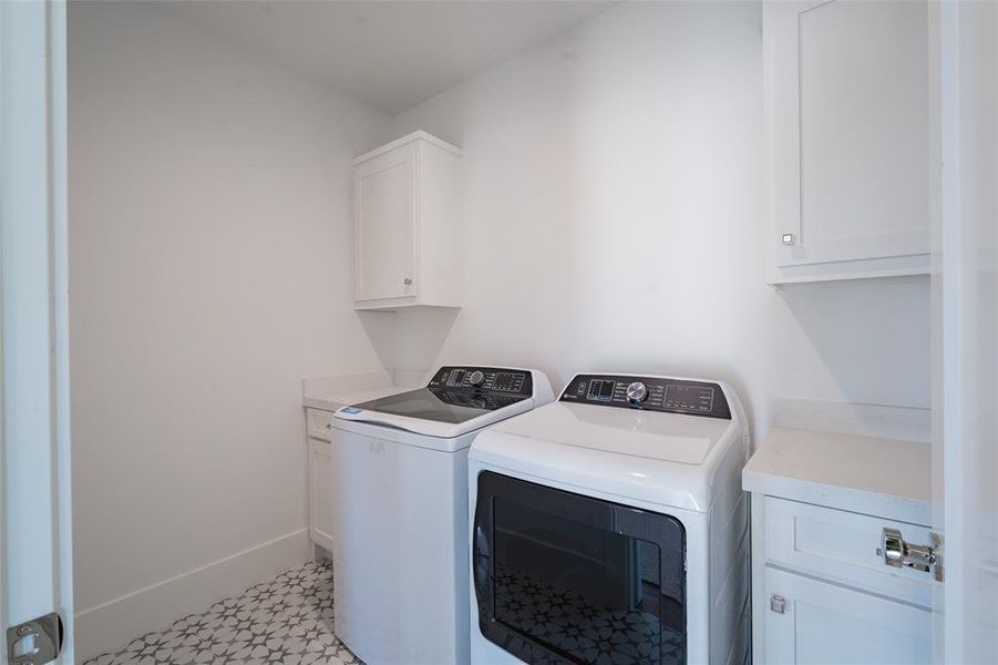 Laundry room with cabinets and washing machine and dryer