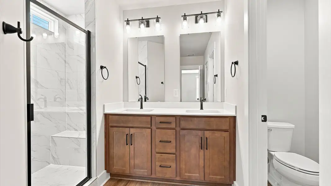 Exceptional en-suite with dual vanity and glass-enclosed walk-in shower for superior everyday comfort at Walnut Ridge