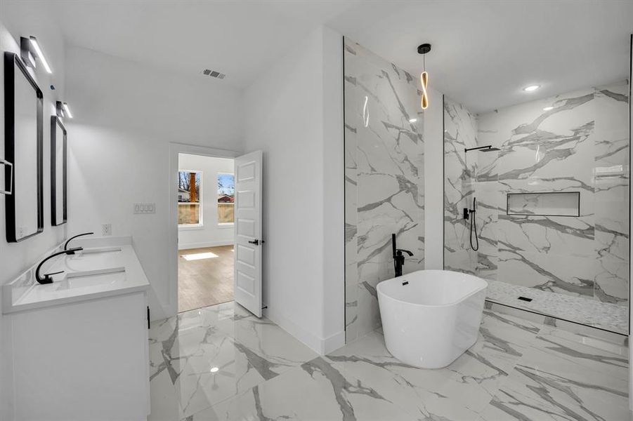 Bathroom featuring vanity and shower with separate bathtub