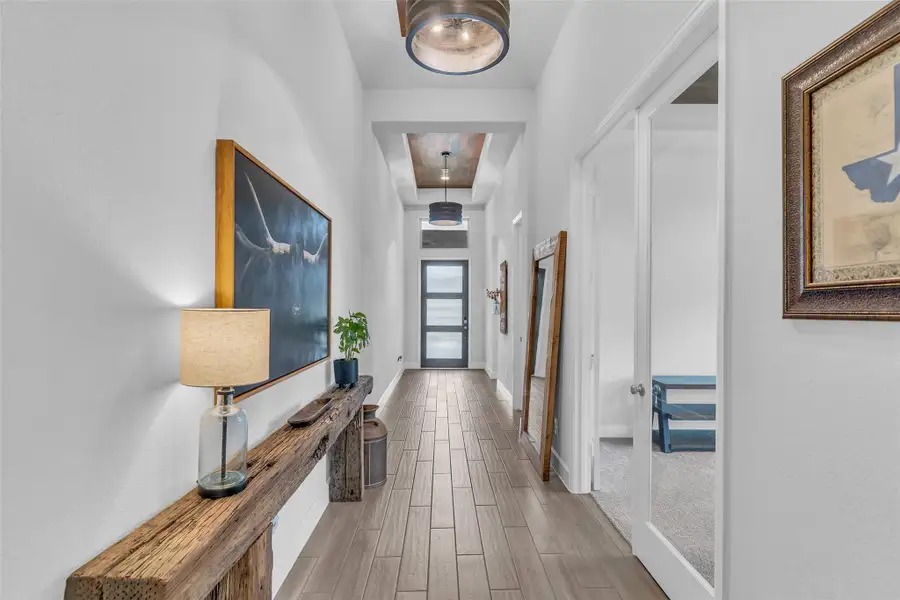 Wood look tile on floor and trayed ceiling in extended entry.