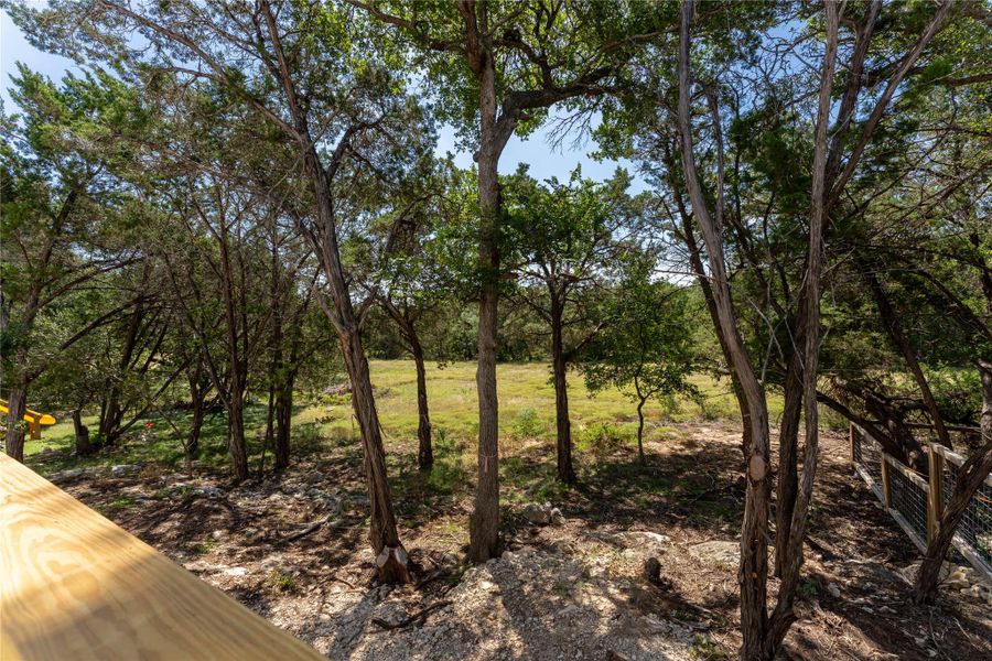 A peaceful spot overlooking the backyard and quiet greenspace beyond—perfect for morning coffee, an evening drink, or simply watching the Hill Country wildlife.