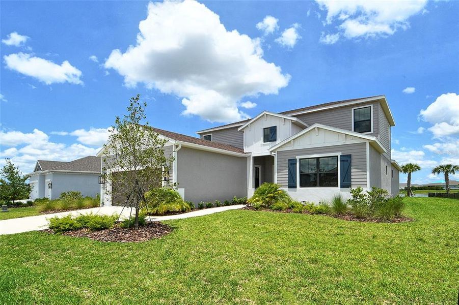 Front exterior of a new home in Canoe Creek, Parrish, FL, highlighting curb appeal (Image 29).