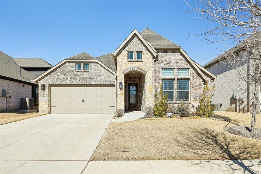 Front exterior of a new home in ArrowBrooke, Aubrey, TX, highlighting curb appeal (Image 1). Front exterior of a new home in ArrowBrooke, Aubrey, TX, highlighting curb appeal (Image 1).