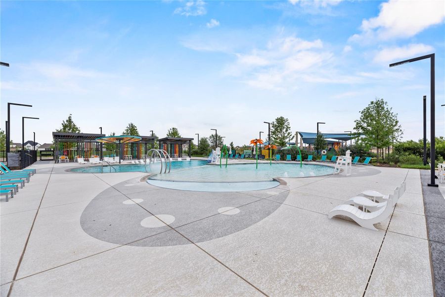 This sparkling community pool offers something for everyone, with a beach-entry design, in-water loungers, shaded seating areas, and a splash zone for endless family fun, all set against beautifully landscaped surroundings.