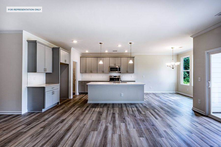 Representative photo of the Melton plan great room open to the kitchen.