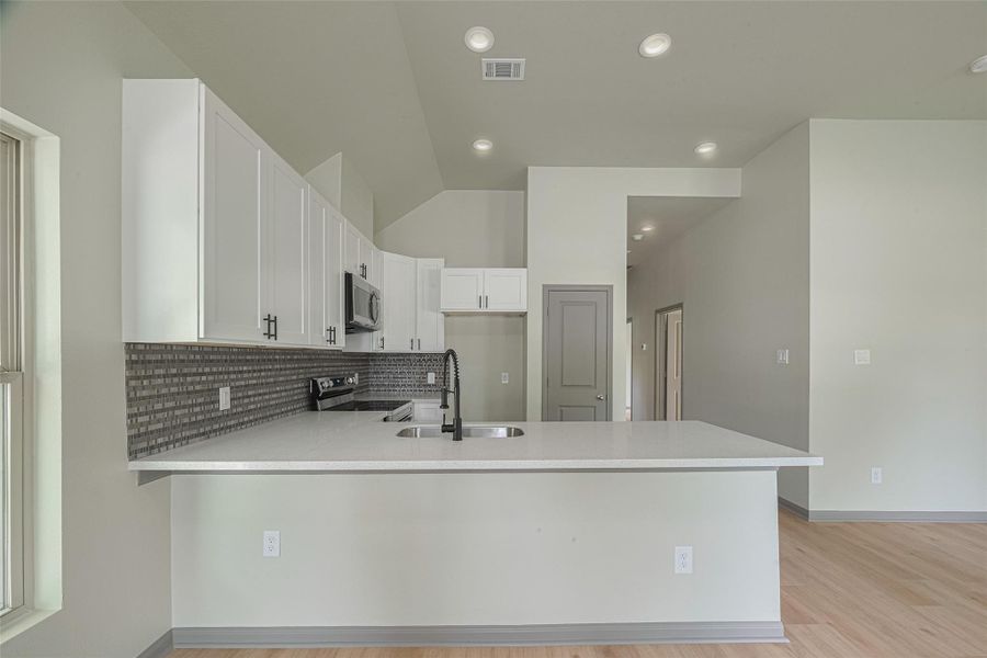 Sleek, new kitchen with top-tier stainless steel appliances. Sleek, new kitchen with top-tier stainless steel appliances.