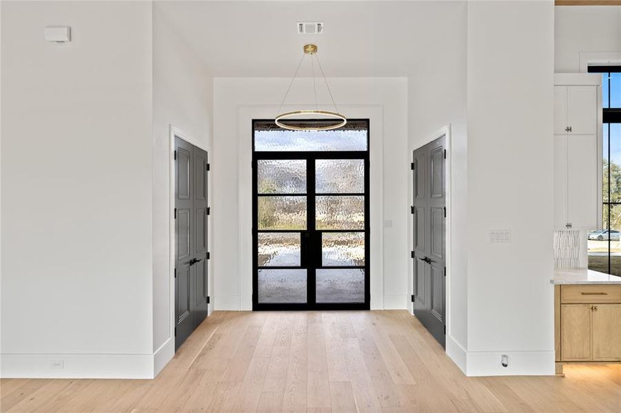 Foyer entrance featuring light wood finished floors and baseboards