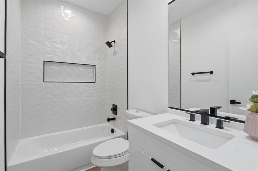 Full bathroom featuring vanity and shower / bath combination Full bathroom featuring vanity and shower / bath combination