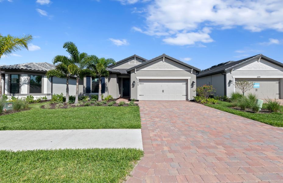 Front exterior of a new home in Del Webb Naples, Immokalee, FL, highlighting curb appeal (Image 22).