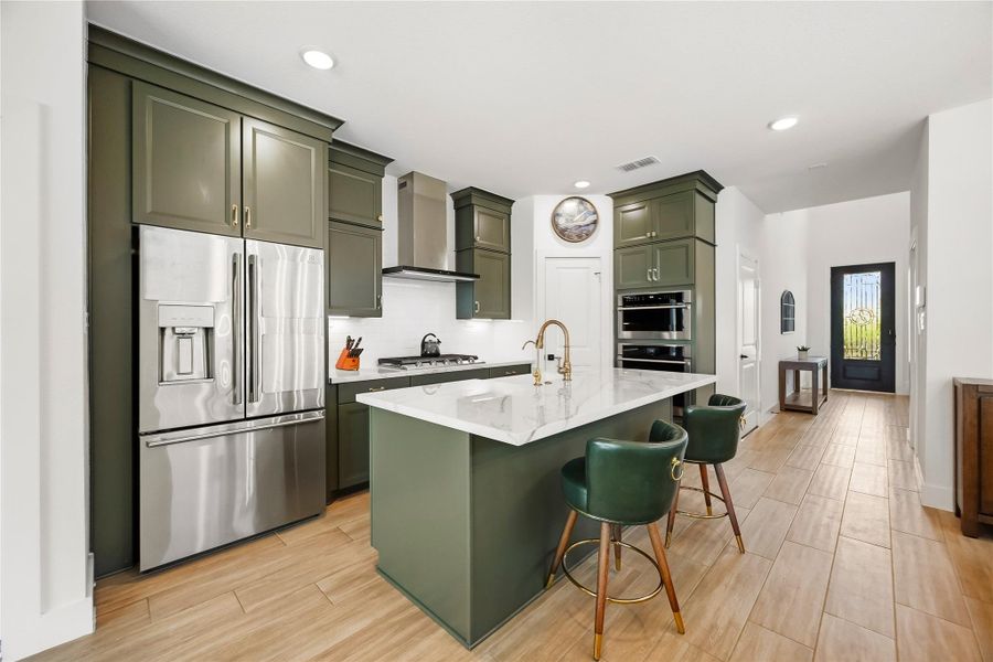 A stainless steel Electrolux appliance package elevates the kitchen with a five-burner gas cooktop, built-in convection ovens and microwave. Soft-close drawers includes dedicated pots-and-pans storage, while the Electrolux French door refrigerator remains with the home for added convenience. A stainless steel Electrolux appliance package elevates the kitchen with a five-burner gas cooktop, built-in convection ovens and microwave. Soft-close drawers includes dedicated pots-and-pans storage, while the Electrolux French door refrigerator remains with the home for added convenience.