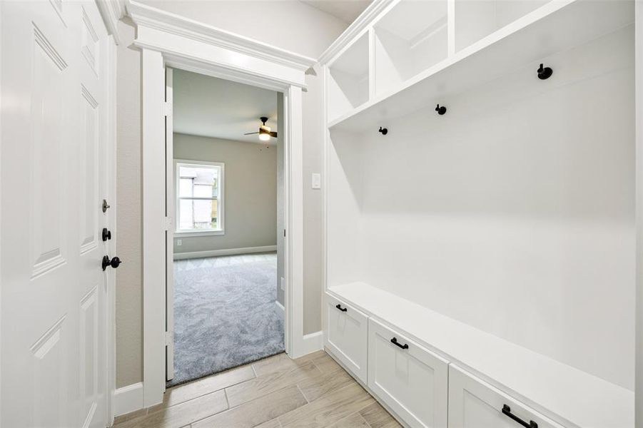 Mudroom featuring ceiling fan and wood finish floors Mudroom featuring ceiling fan and wood finish floors
