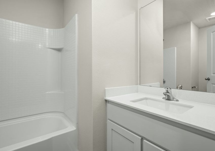The secondary bathroom has a sprawling vanity and shower-tub combo. The secondary bathroom has a sprawling vanity and shower-tub combo.