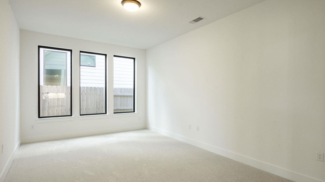 Carpeted empty room with baseboards Carpeted empty room with baseboards
