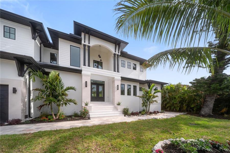 Front exterior of a new home in , Longboat Key, FL, highlighting curb appeal (Image 28). Front exterior of a new home in , Longboat Key, FL, highlighting curb appeal (Image 28).