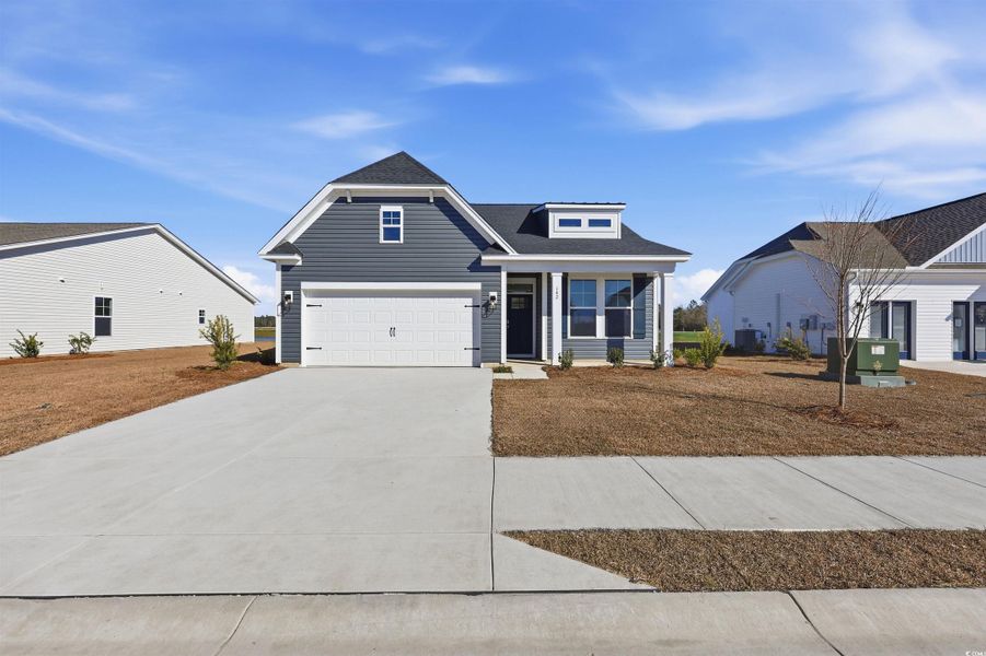 View of front of house with driveway, a shingled roof, and an attached garage View of front of house with driveway, a shingled roof, and an attached garage