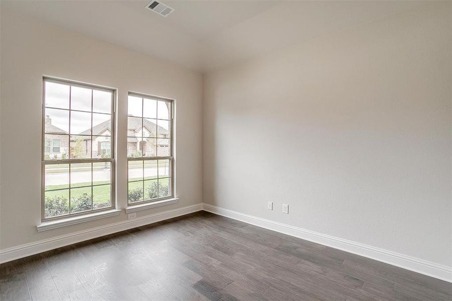 Spare room featuring dark hardwood / wood-style flooring