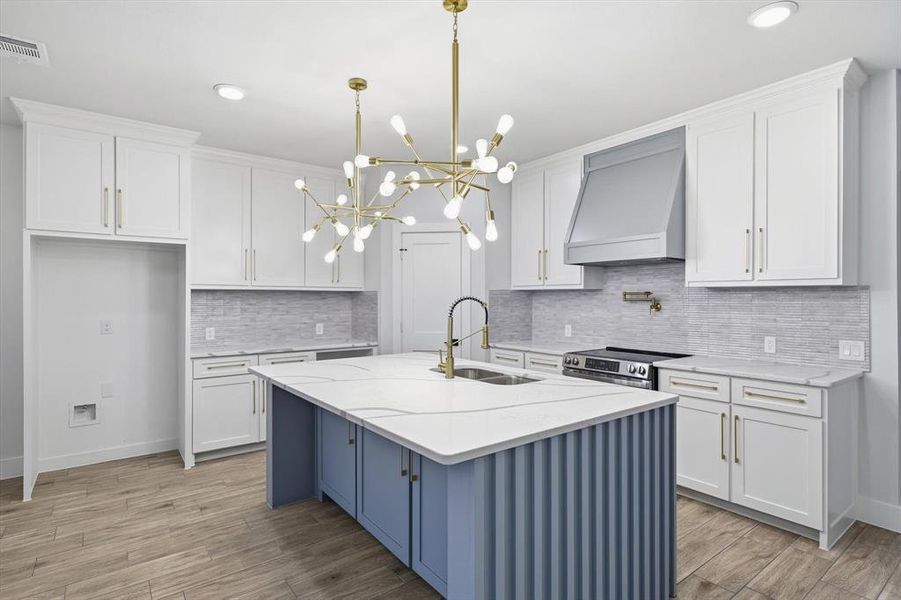 Kitchen with white cabinetry, custom exhaust hood, light stone countertops, light wood-type flooring, and recessed lighting