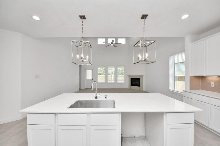 All of this overlooks your expansive family room, creating a perfect space for culinary delights and family gatherings. Sample photo of completed home with similar floor plan. Actual colors and selections may vary. All of this overlooks your expansive family room, creating a perfect space for culinary delights and family gatherings. Sample photo of completed home with similar floor plan. Actual colors and selections may vary.