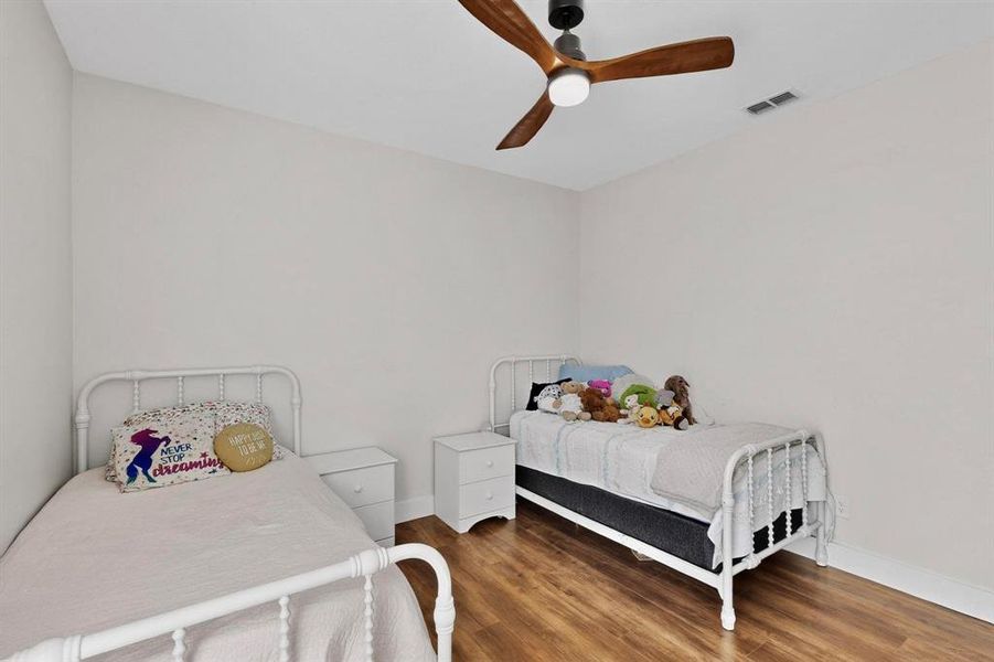 Bedroom featuring wood finished floors and ceiling fan