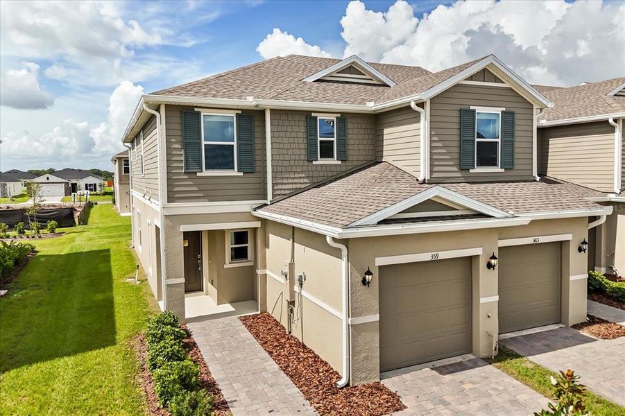 Front exterior of a new home in Reserve at Forest Lake Townhomes, Lake Wales, FL, highlighting curb appeal (Image 17). Front exterior of a new home in Reserve at Forest Lake Townhomes, Lake Wales, FL, highlighting curb appeal (Image 17).
