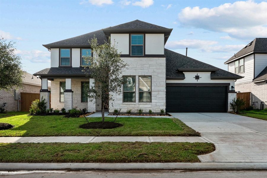 Front exterior of a new home in Marvida, Cypress, TX, highlighting curb appeal (Image 1). Front exterior of a new home in Marvida, Cypress, TX, highlighting curb appeal (Image 1).
