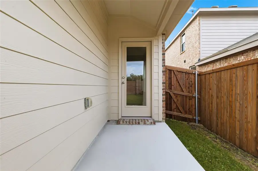 View of exterior entry featuring a patio and a gate View of exterior entry featuring a patio and a gate