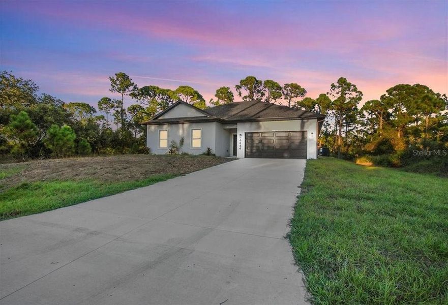 Front exterior of a new home in , North Port, FL, highlighting curb appeal (Image 1). Front exterior of a new home in , North Port, FL, highlighting curb appeal (Image 1).