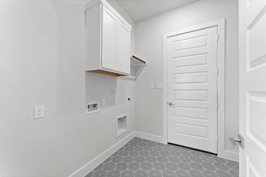 Utility Room with Washer and Dryer Connections, Hanging Bar, and Storage Cabinet.