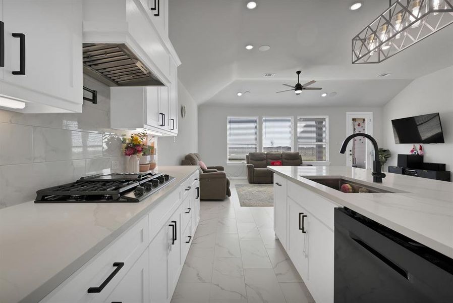 Kitchen with custom range hood, open floor plan, a sink, gas cooktop, and dishwasher