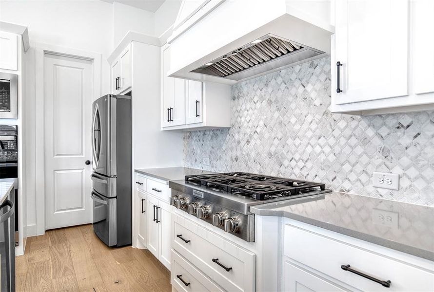 Beautiful, upgraded backsplash and upgraded appliances.