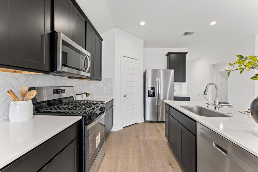 High-end stainless steel appliances and an abundance of rich cabinetry make organization effortless and stylish.