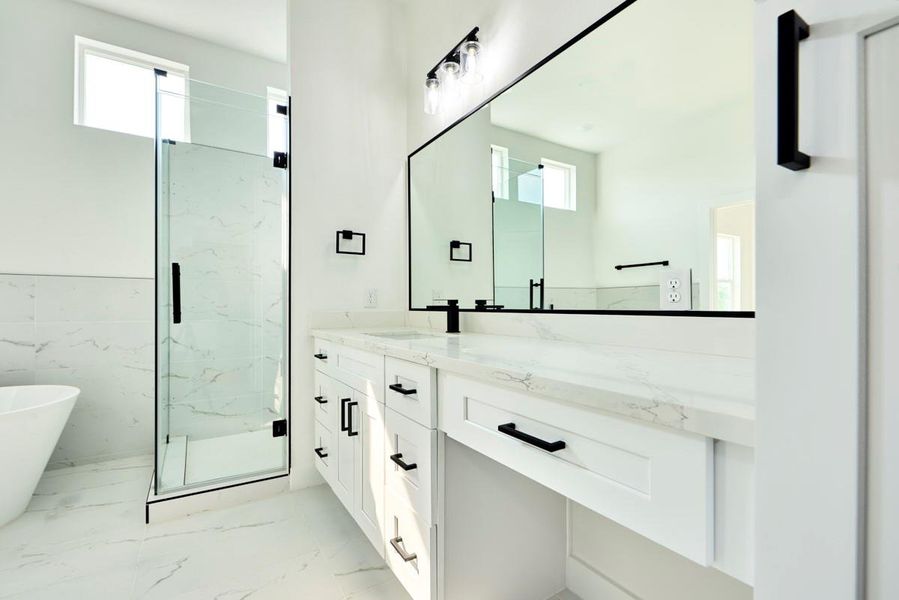 Designed for comfort and convenience, the primary bathroom features double sinks with sleek, modern fixtures. The spacious vanity area offers ample storage, making it a perfect blend of style and function. Designed for comfort and convenience, the primary bathroom features double sinks with sleek, modern fixtures. The spacious vanity area offers ample storage, making it a perfect blend of style and function.