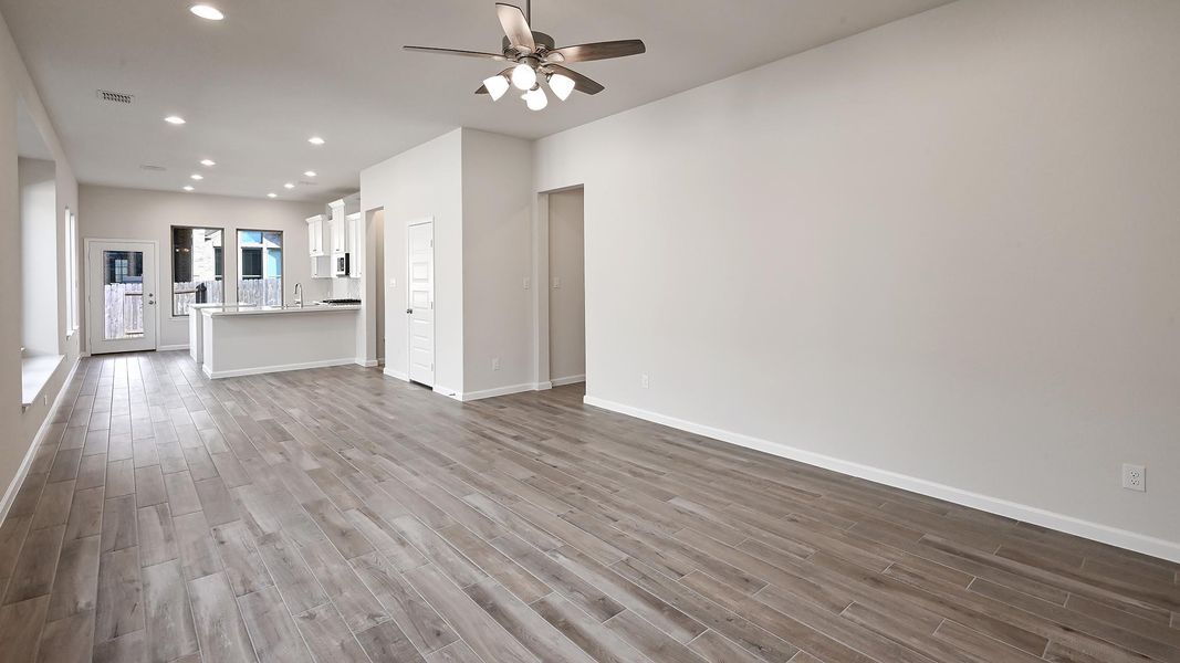 Unfurnished living room with recessed lighting, light wood-type flooring, and a ceiling fan