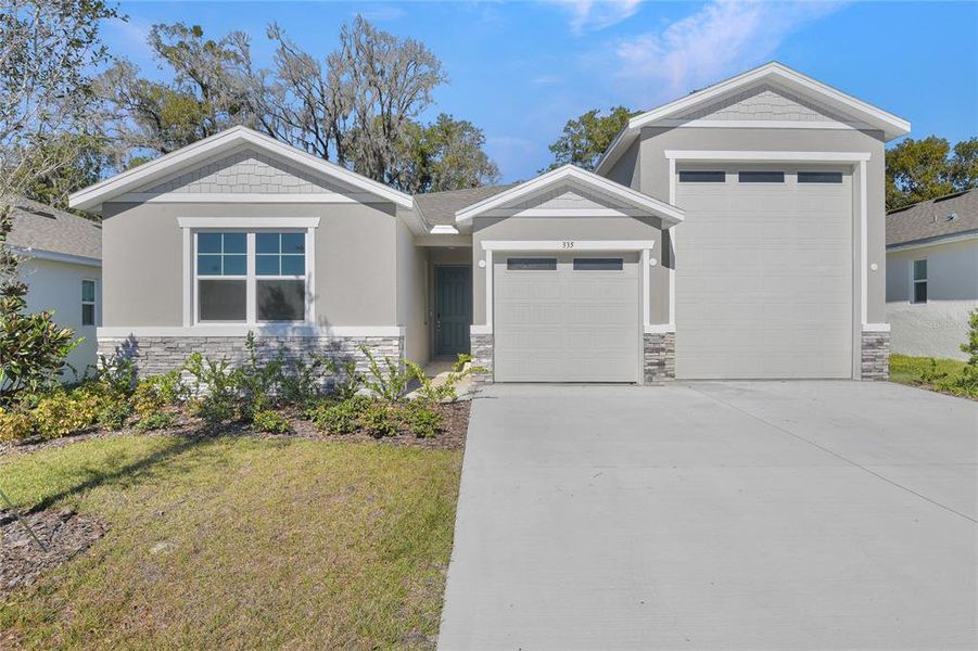 Front exterior of a new home in Seasons at Grandview Gardens, Deland, FL, highlighting curb appeal (Image 1). Front exterior of a new home in Seasons at Grandview Gardens, Deland, FL, highlighting curb appeal (Image 1).