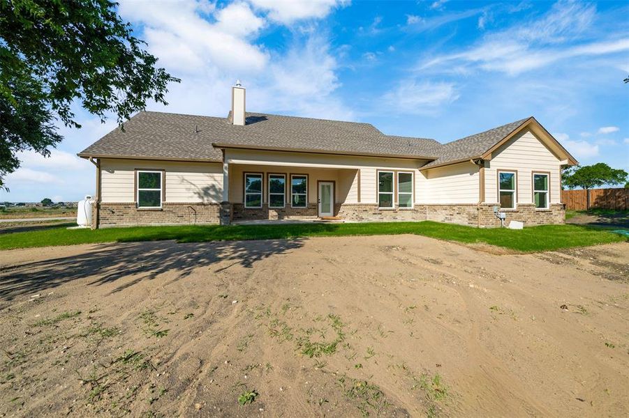 Rear view of house featuring brick siding and a chimney Rear view of house featuring brick siding and a chimney