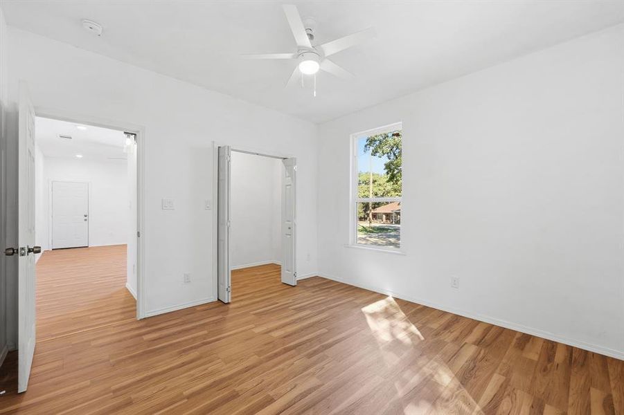 Bedroom 2 featuring light wood-style floors and a ceiling fan