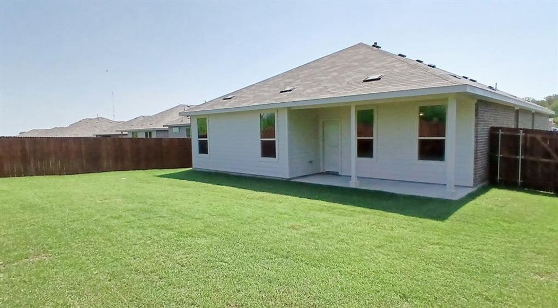 Front exterior of a new home in The Canyons, Keene, TX, highlighting curb appeal (Image 10).
