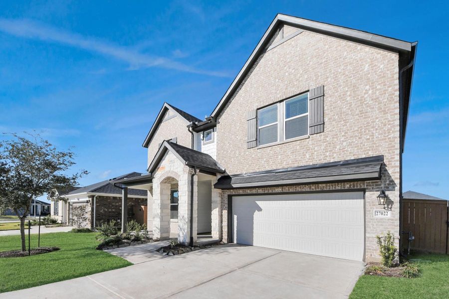 Front exterior of a new home in Sunterra: Landmark Collection, Katy, TX, highlighting curb appeal (Image 23).