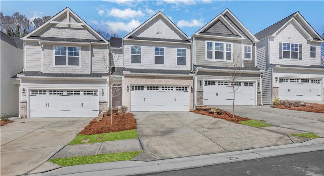 Front exterior of a new home in Villas at Dawsonville Townhomes, Dawsonville, GA, highlighting curb appeal (Image 1). Front exterior of a new home in Villas at Dawsonville Townhomes, Dawsonville, GA, highlighting curb appeal (Image 1).