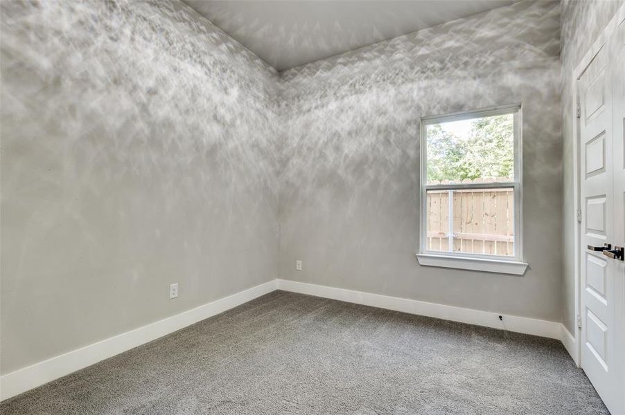 Unfurnished room with carpet floors and baseboards Unfurnished room with carpet floors and baseboards