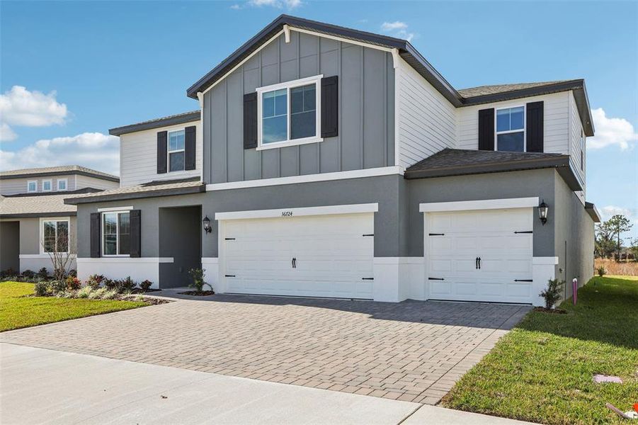 Front exterior of a new home in Two Rivers - Signature Series, Zephyrhills, FL, highlighting curb appeal (Image 2). Front exterior of a new home in Two Rivers - Signature Series, Zephyrhills, FL, highlighting curb appeal (Image 2).