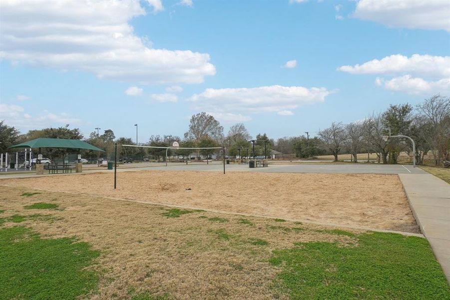 Surrounding community featuring a lawn and volleyball court