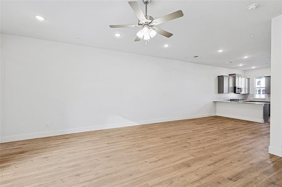 Unfurnished living room with recessed lighting, light wood-type flooring, and ceiling fan