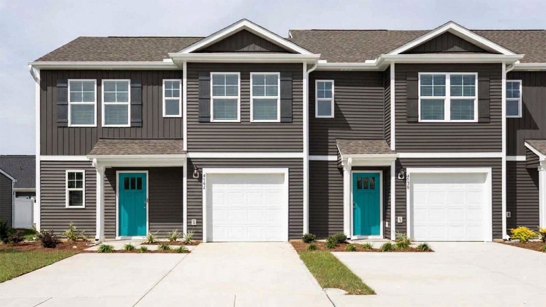 Front exterior of a new home in Townes at Seabrooke, Leland, NC, highlighting curb appeal (Image 1). Front exterior of a new home in Townes at Seabrooke, Leland, NC, highlighting curb appeal (Image 1).
