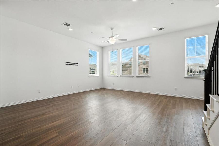 Spacious Living room with beautiful luxury vinyl plank and abeautiful view of the outside.