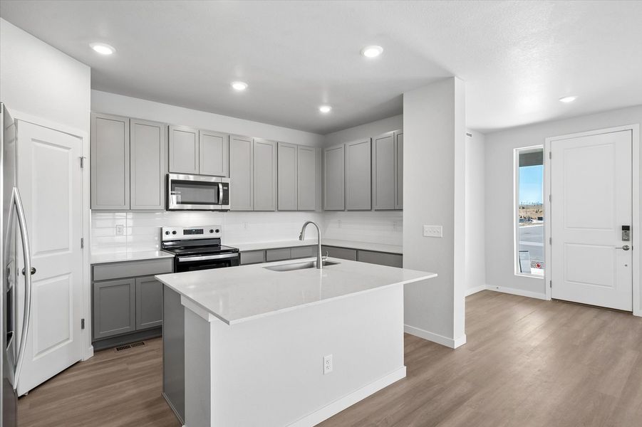 A kitchen with white cabinets.