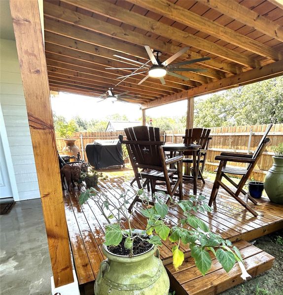 An inviting covered patio featuring robust wooden construction and functional ceiling fans for outdoor comfort. An inviting covered patio featuring robust wooden construction and functional ceiling fans for outdoor comfort.