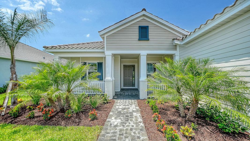 Front exterior of a new home in Grand Park Real Estate and Homes for Sale in Sarasota, FL - Neal Communities, Sarasota, FL, highlighting curb appeal (Image 2). Front exterior of a new home in Grand Park Real Estate and Homes for Sale in Sarasota, FL - Neal Communities, Sarasota, FL, highlighting curb appeal (Image 2).